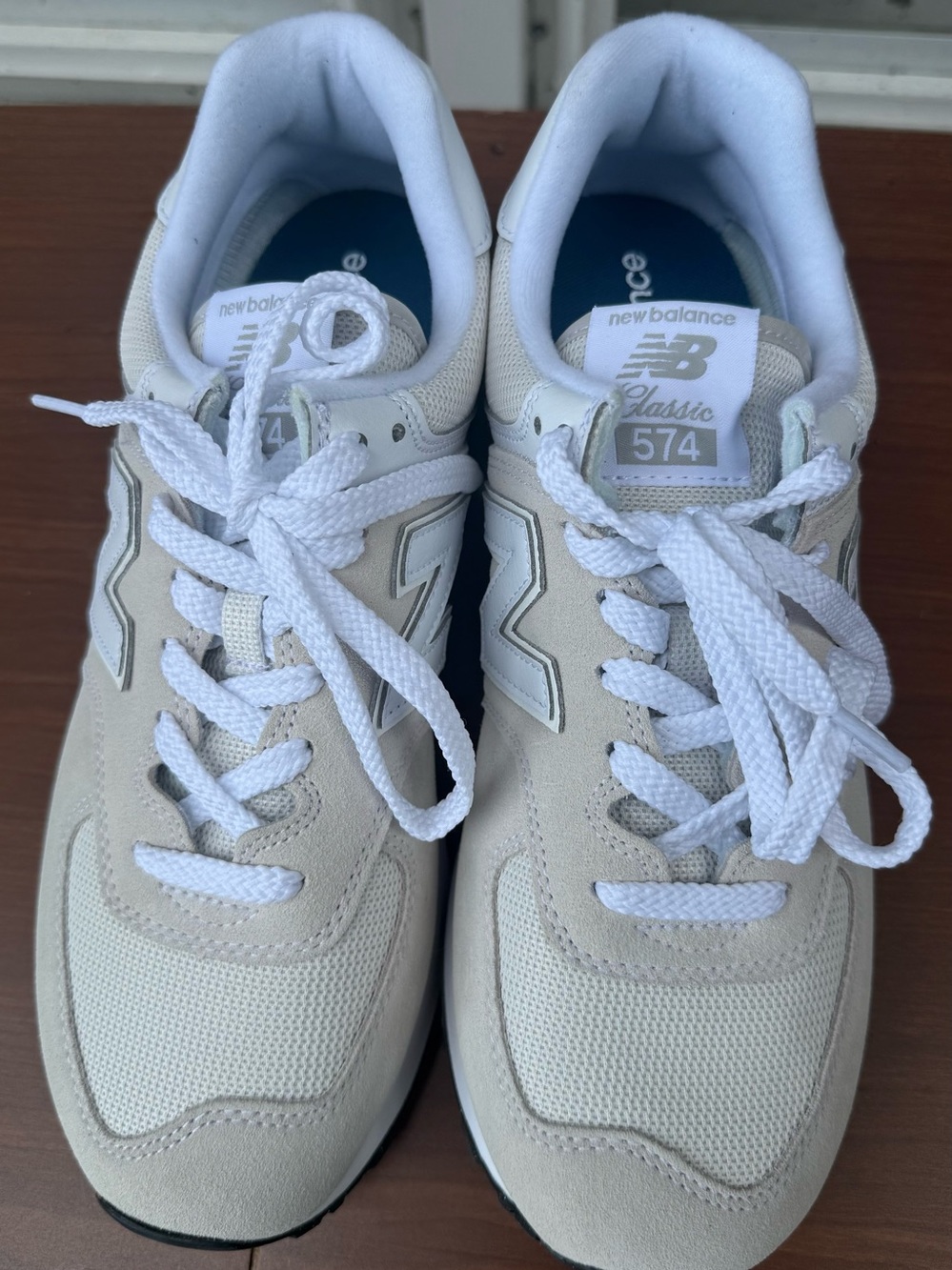 New Balance women’s 574 Sneakers in “Nimbus Cloud White”